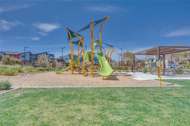 community play area with fence and a lawn