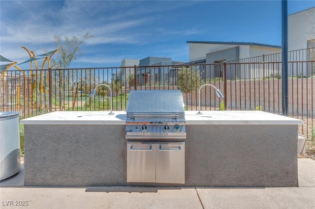 view of patio / terrace with a grill, fence, and area for grilling
