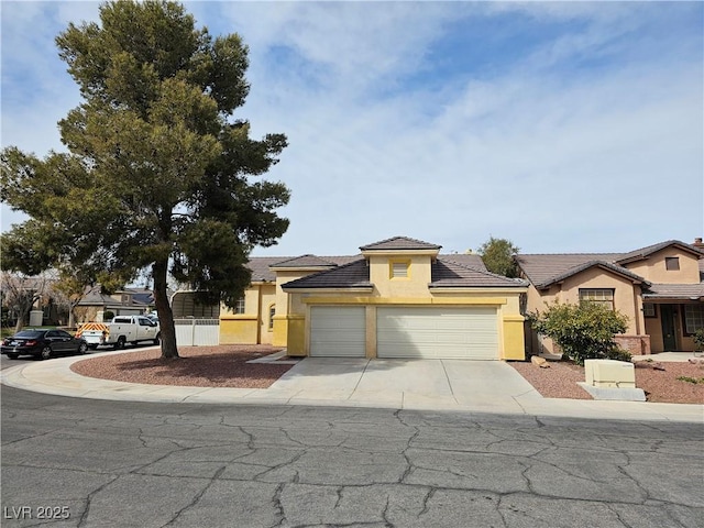 view of front of home featuring a tile roof, a garage, driveway, and stucco siding