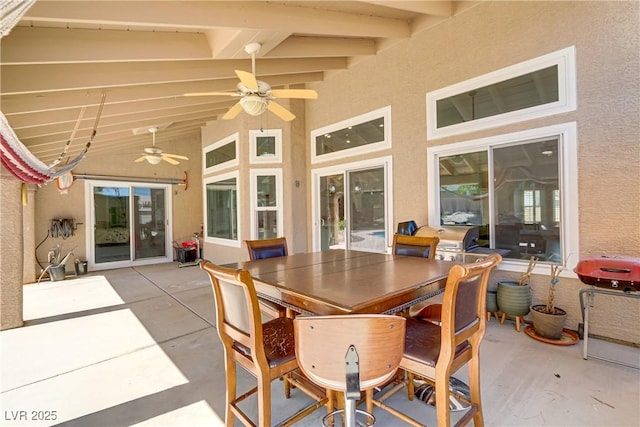 view of patio with a grill, outdoor dining space, and a ceiling fan