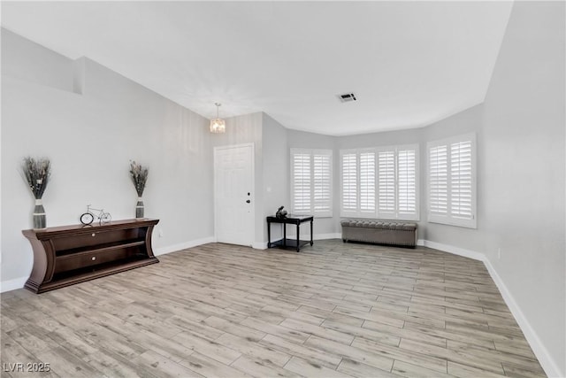 sitting room with visible vents, baseboards, and wood finished floors