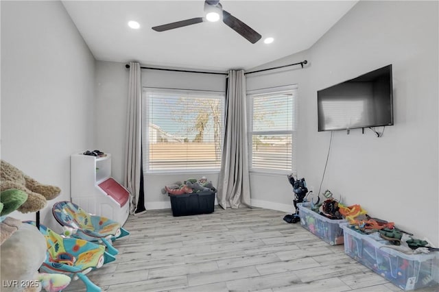 rec room featuring baseboards, recessed lighting, ceiling fan, vaulted ceiling, and light wood-type flooring