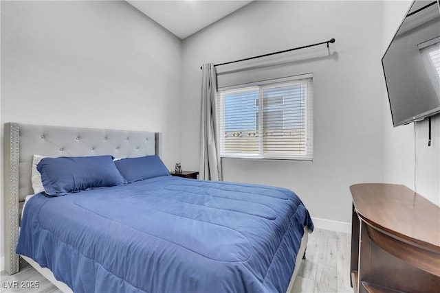 bedroom featuring baseboards and wood finished floors