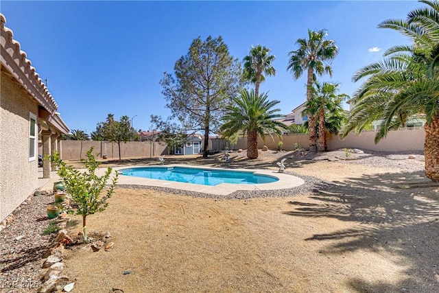 view of pool featuring a fenced in pool, an outbuilding, a fenced backyard, and a patio area