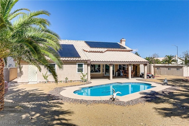 pool with a patio and fence