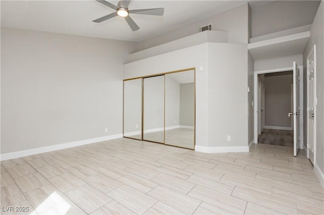 unfurnished bedroom featuring a closet, baseboards, visible vents, and a ceiling fan