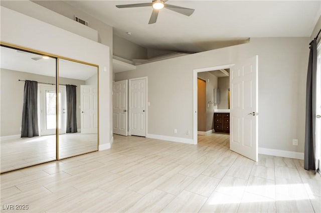 unfurnished bedroom with visible vents, ceiling fan, baseboards, vaulted ceiling, and a closet