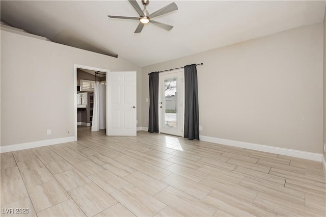 spare room featuring baseboards, lofted ceiling, and ceiling fan