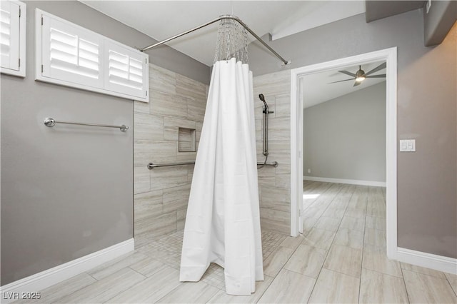 full bath featuring a ceiling fan, baseboards, and a tile shower