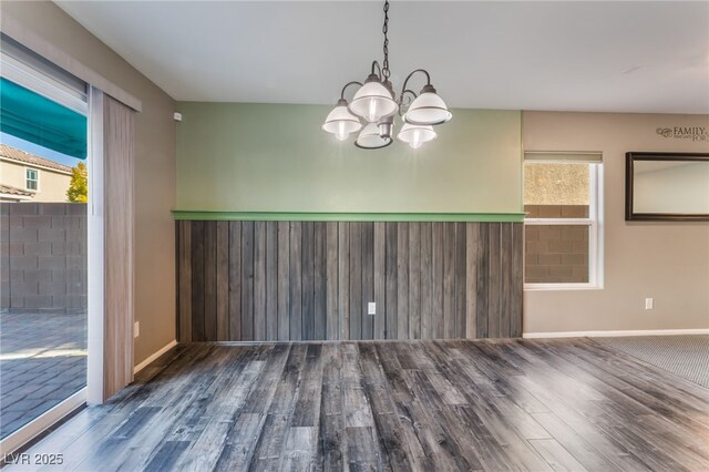 7219 Quiet Spring St, North Las Vegas, NV 89084 - unfurnished dining area with wood finished floors, a notable chandelier, and baseboards