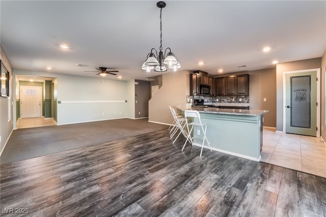 7219 Quiet Spring St, North Las Vegas, NV 89084 - kitchen featuring tasteful backsplash, black microwave, baseboards, and recessed lighting