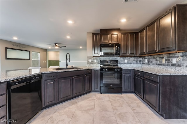 7219 Quiet Spring St, North Las Vegas, NV 89084 - kitchen featuring black appliances, ceiling fan, light stone counters, and a sink