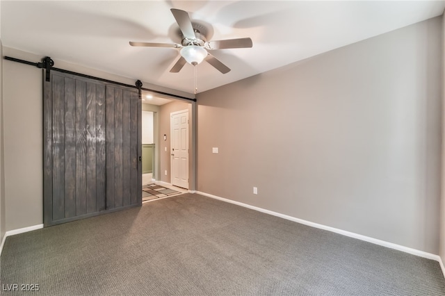 7219 Quiet Spring St, North Las Vegas, NV 89084 - spare room featuring baseboards, a barn door, a ceiling fan, and carpet