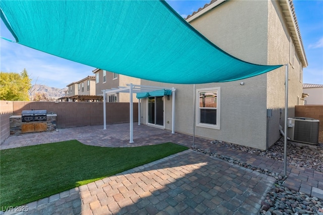 7219 Quiet Spring St, North Las Vegas, NV 89084 - rear view of property featuring central AC, a fenced backyard, stucco siding, and a pergola