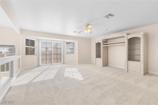 unfurnished bedroom with visible vents, light carpet, baseboards, and a ceiling fan