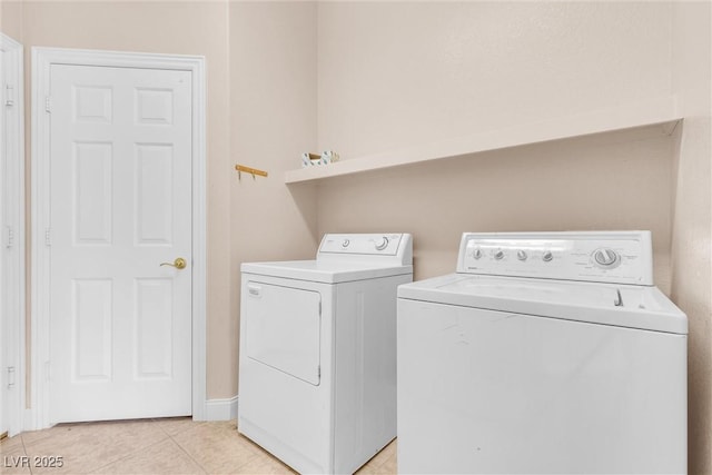 laundry area with light tile patterned floors, laundry area, and independent washer and dryer