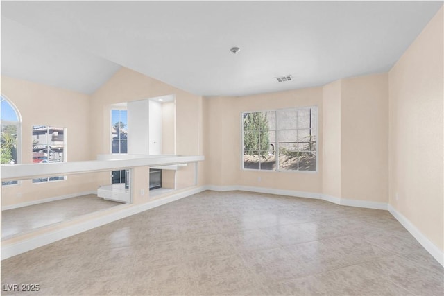 unfurnished living room featuring visible vents and baseboards