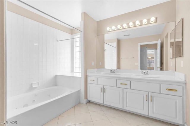 full bath featuring tile patterned flooring, double vanity, a whirlpool tub, and a sink