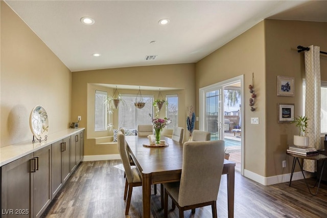 dining space with lofted ceiling, recessed lighting, baseboards, and dark wood-style flooring