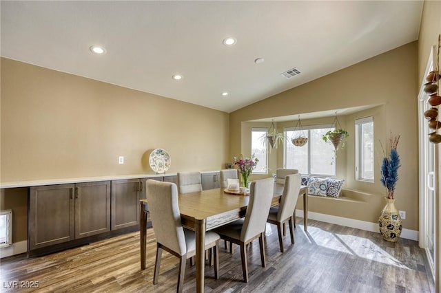 dining room with visible vents, wood finished floors, recessed lighting, baseboards, and lofted ceiling