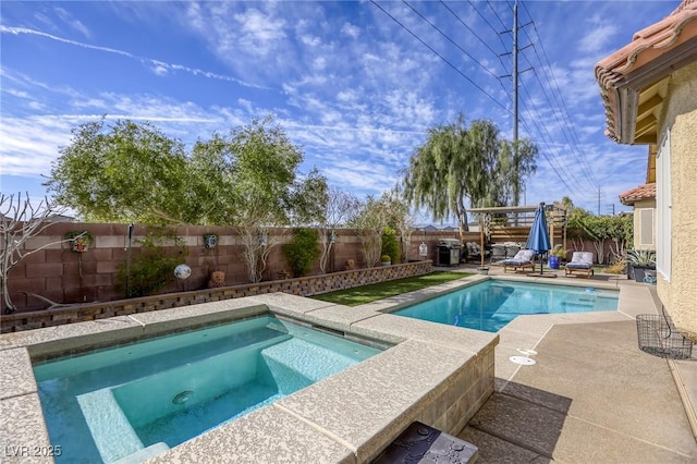 view of pool featuring a patio area, an in ground hot tub, and a fenced backyard