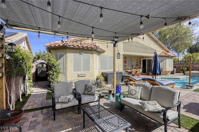 view of patio / terrace featuring a gate, a fenced in pool, outdoor lounge area, and fence