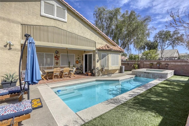 view of swimming pool with a fenced in pool, fence, outdoor dining space, an in ground hot tub, and a patio