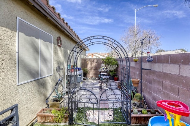 exterior space with a patio area, central AC unit, and a fenced backyard