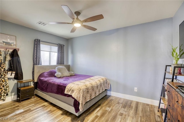 bedroom with visible vents, a ceiling fan, light wood-type flooring, and baseboards