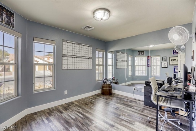 office featuring visible vents, baseboards, and wood finished floors