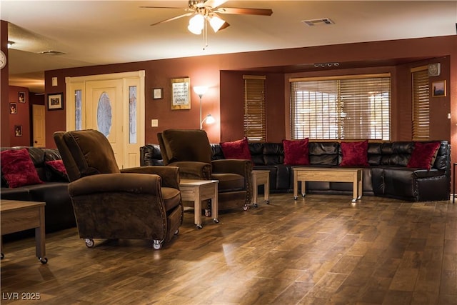 living room featuring visible vents, a ceiling fan, and wood finished floors