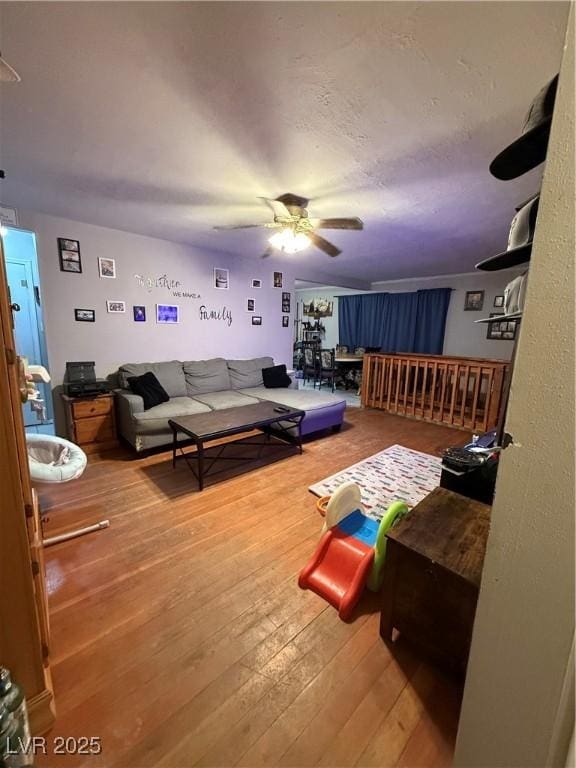 1016 Park Ave, Ely, NV 89301 - living room with hardwood / wood-style floors, a textured ceiling, and a ceiling fan