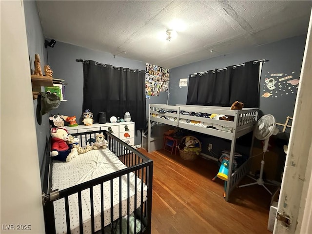 1016 Park Ave, Ely, NV 89301 - bedroom with a textured ceiling and wood finished floors