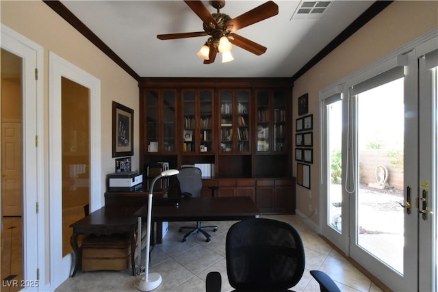 office with light tile patterned floors, visible vents, ceiling fan, and ornamental molding