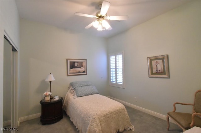 carpeted bedroom with a closet, baseboards, and ceiling fan