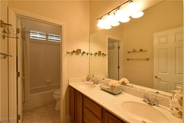 full bathroom featuring tile patterned flooring, double vanity, toilet, and a sink