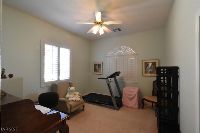 workout area with visible vents, carpet floors, and a ceiling fan