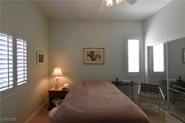 bedroom featuring baseboards and ceiling fan