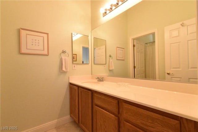 bathroom featuring tile patterned floors, baseboards, and vanity