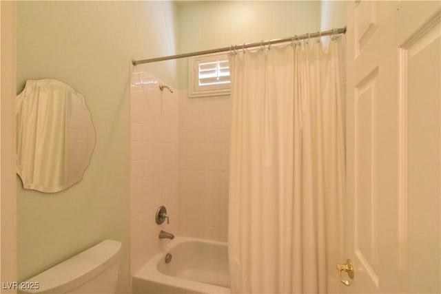 bathroom featuring shower / bath combo with shower curtain and toilet