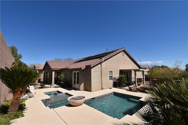 view of pool with a fenced in pool, an in ground hot tub, a fenced backyard, and a patio area