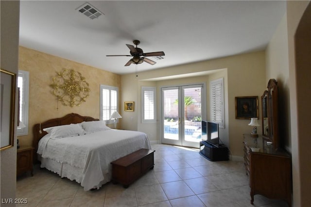 bedroom featuring access to exterior, visible vents, multiple windows, and light tile patterned flooring