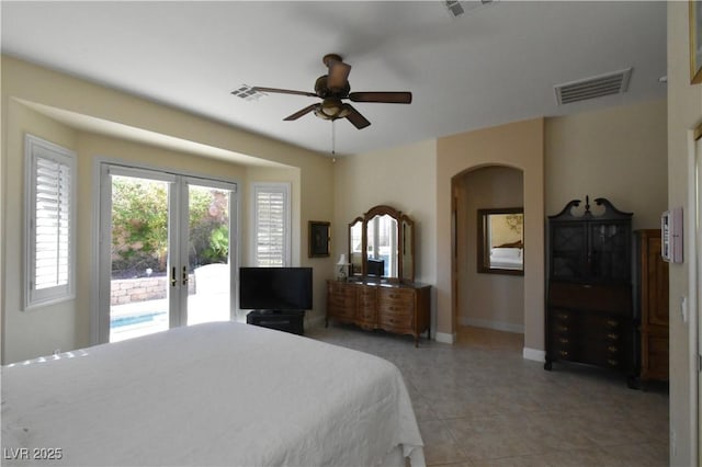 bedroom with visible vents, arched walkways, access to exterior, and french doors