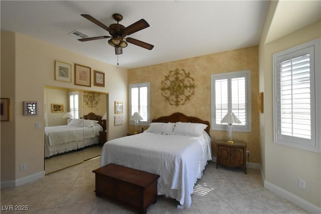 bedroom featuring visible vents, multiple windows, and baseboards