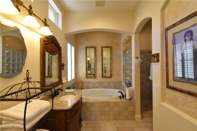 full bath featuring visible vents, walk in shower, a garden tub, tile patterned floors, and vanity