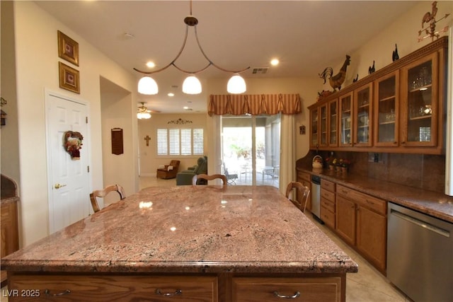 kitchen with backsplash, glass insert cabinets, light stone counters, brown cabinets, and stainless steel dishwasher