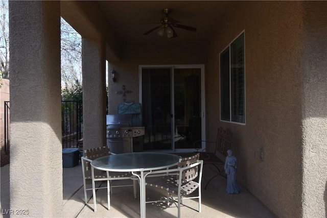 view of patio featuring outdoor dining space, a ceiling fan, and fence