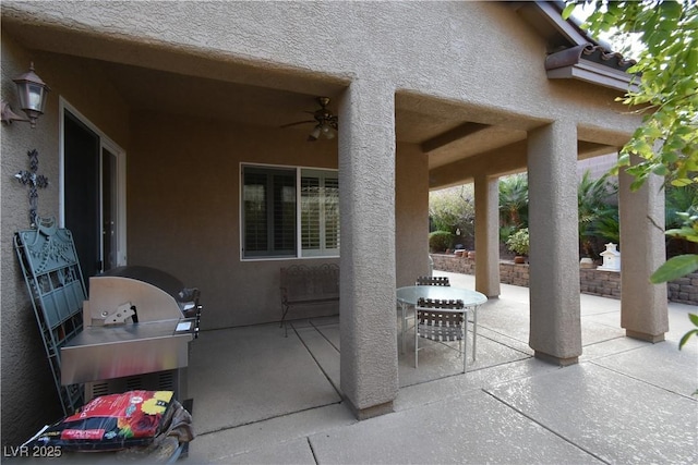 view of patio with area for grilling and a ceiling fan