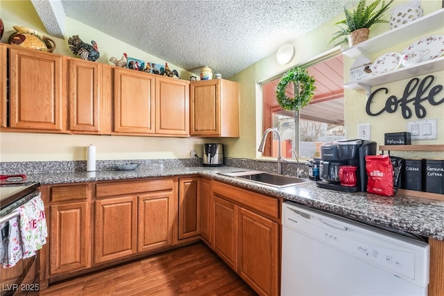 kitchen with dark wood finished floors, lofted ceiling, a sink, a textured ceiling, and dishwasher