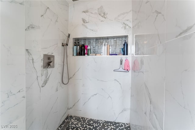 bathroom with a marble finish shower